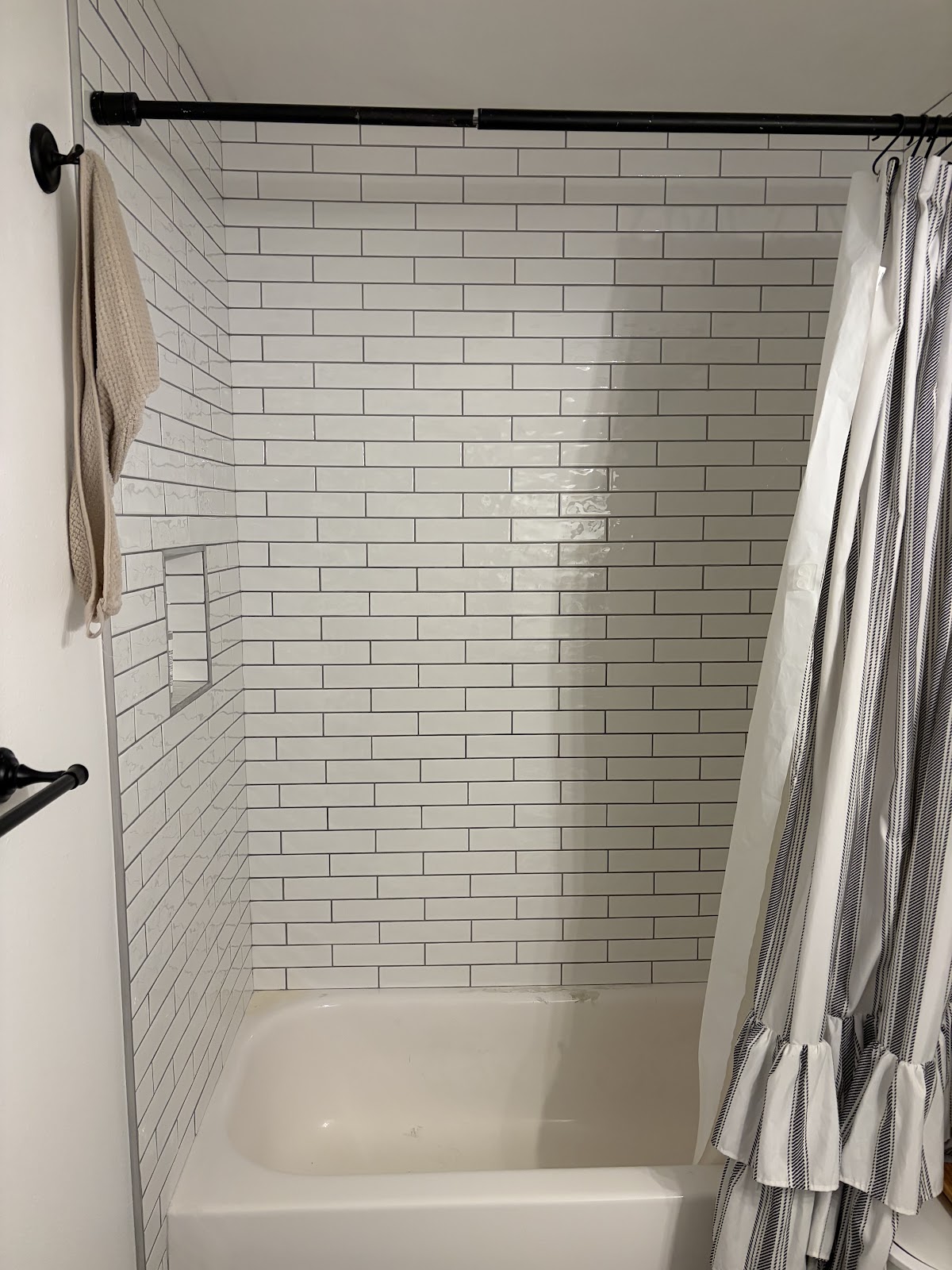 White subway-tile tub and shower surround